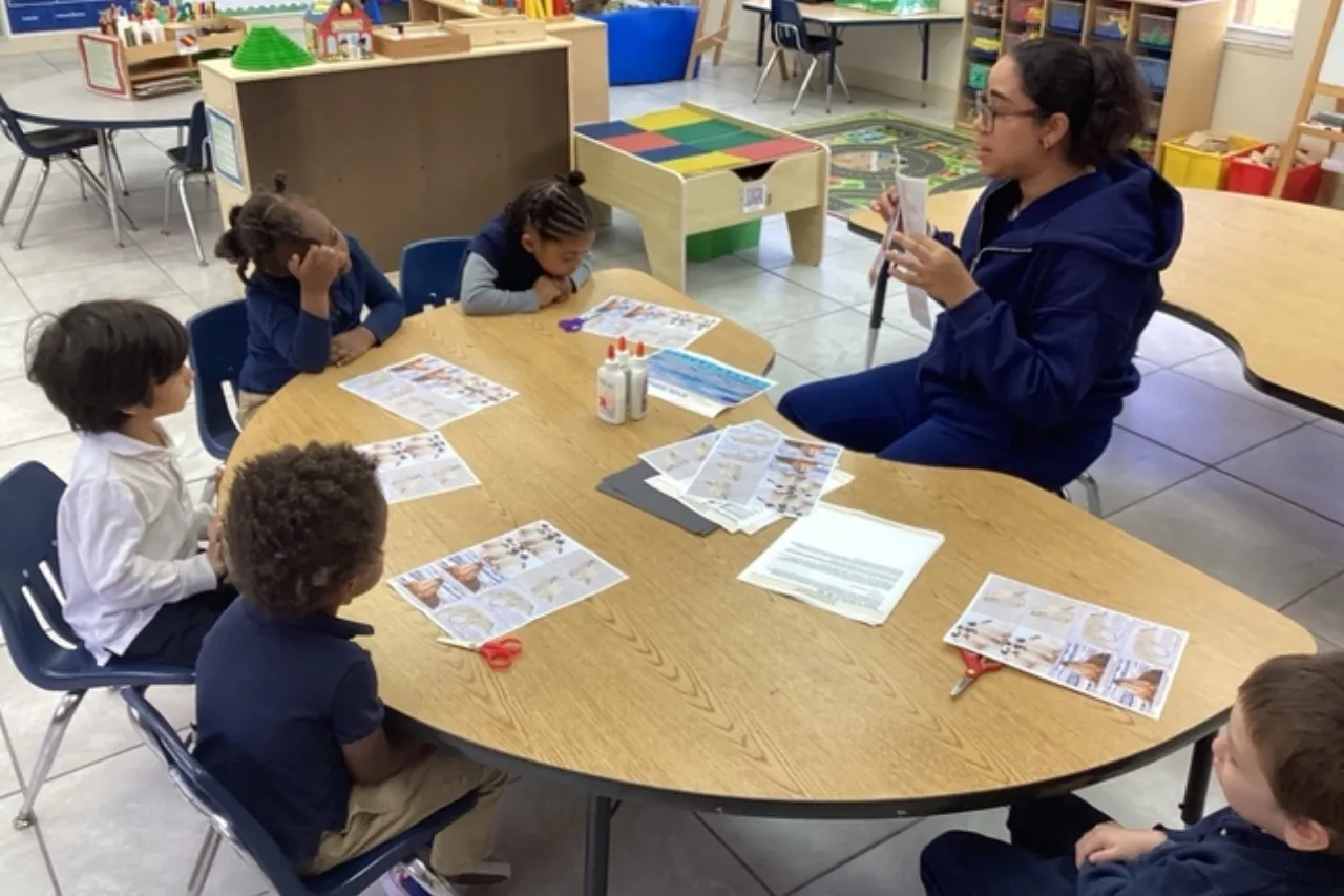 Teacher guiding a child during a classroom learning activity at Horizons Learning Centers in Orlando.