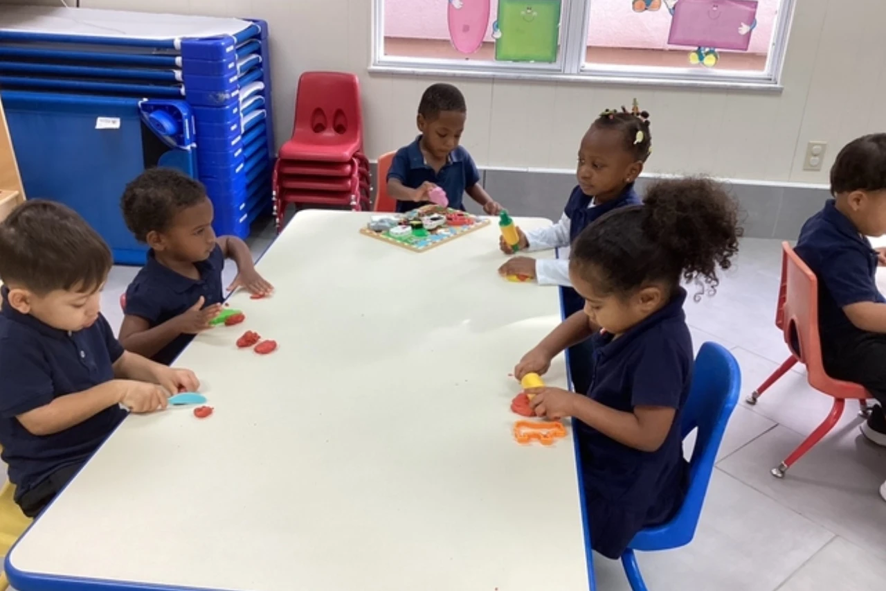 Toddlers participating in a table play activity at Horizons Childcare & Learning Center.