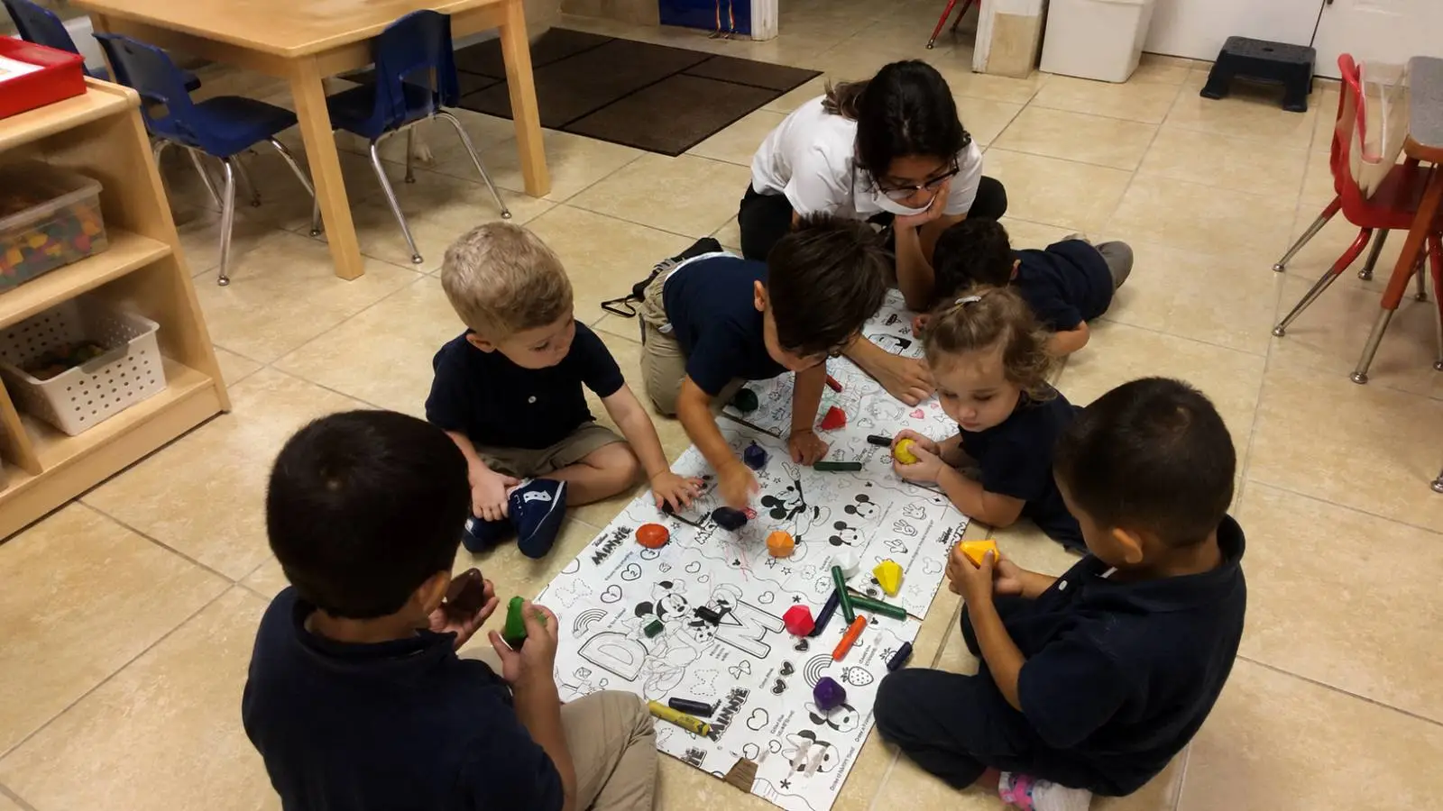 Teacher guiding children during a classroom activity at Horizons Childcare & Learning Center in Orlando.
